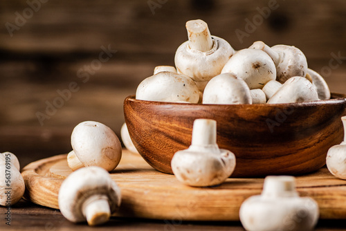 Mushrooms in a bowl on a cutting board. 