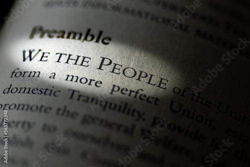The Preamble of the US constitution in textbook highlighting We the People
