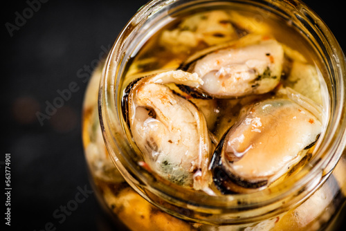 Open jar with pickled mussels. 