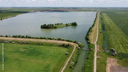 A picturesque lake with a desert island. Near the pedestrian bridge over the river. High quality FullHD footage