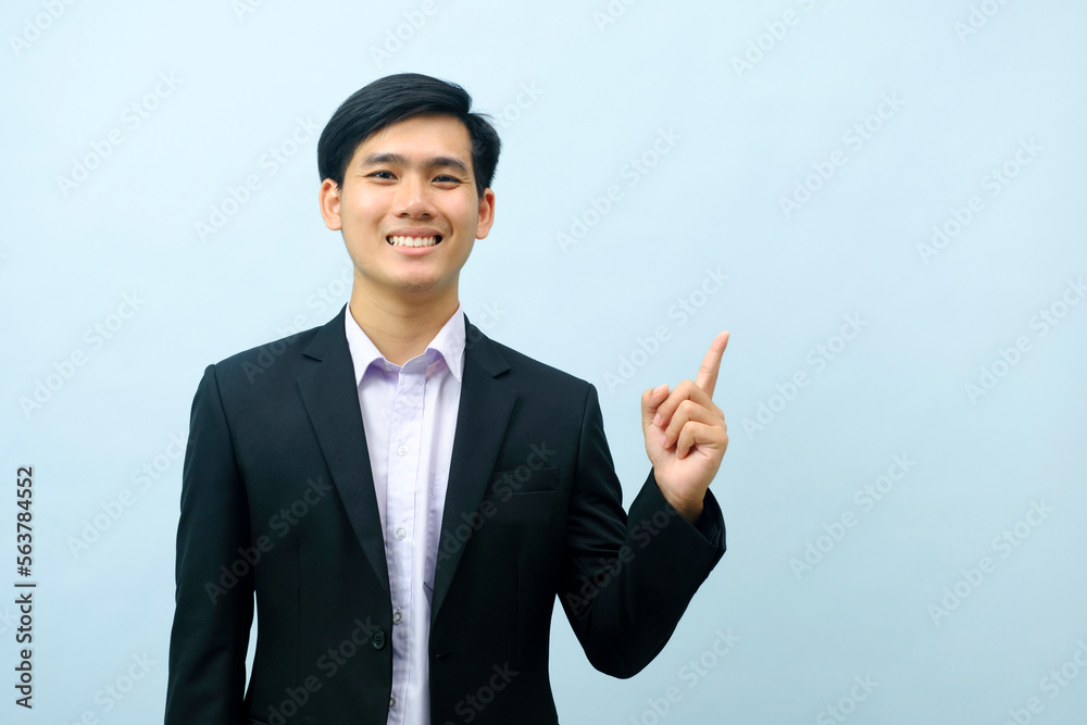 Portrait of businessman pointing and looking at camera. Portrait of businessman pointing and looking at camera.