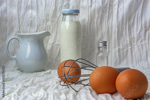 set of products and a whisk for making omelet, on a white background photo