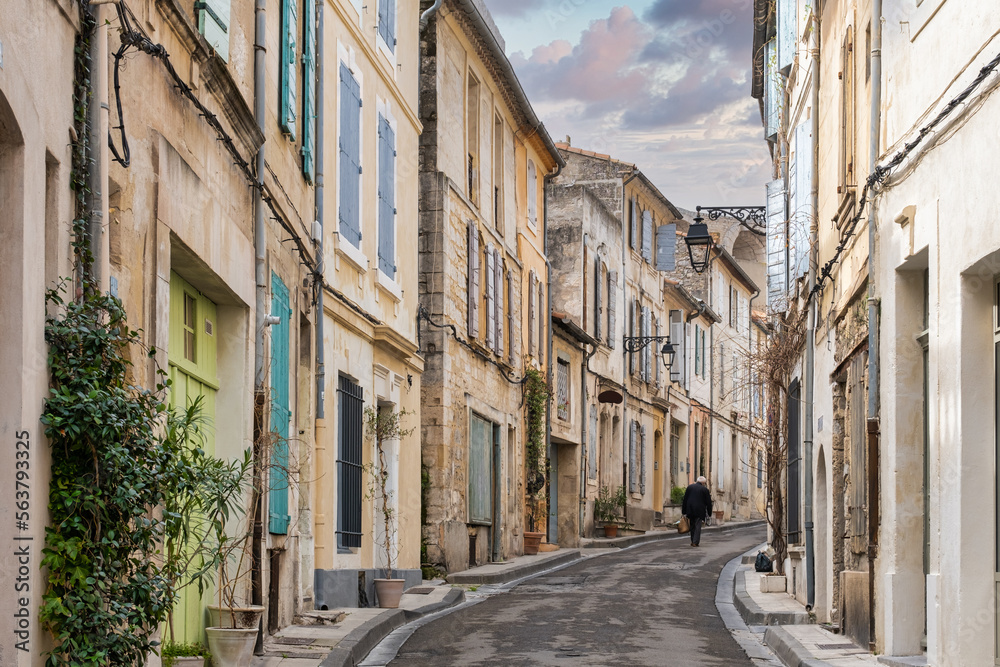 A man walk in a medieval street of Arles city in France
