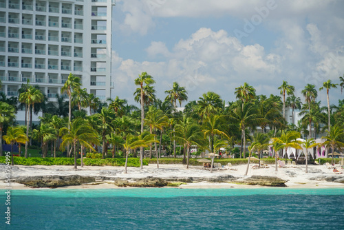 landscape of tropical beach and palm trees with building
