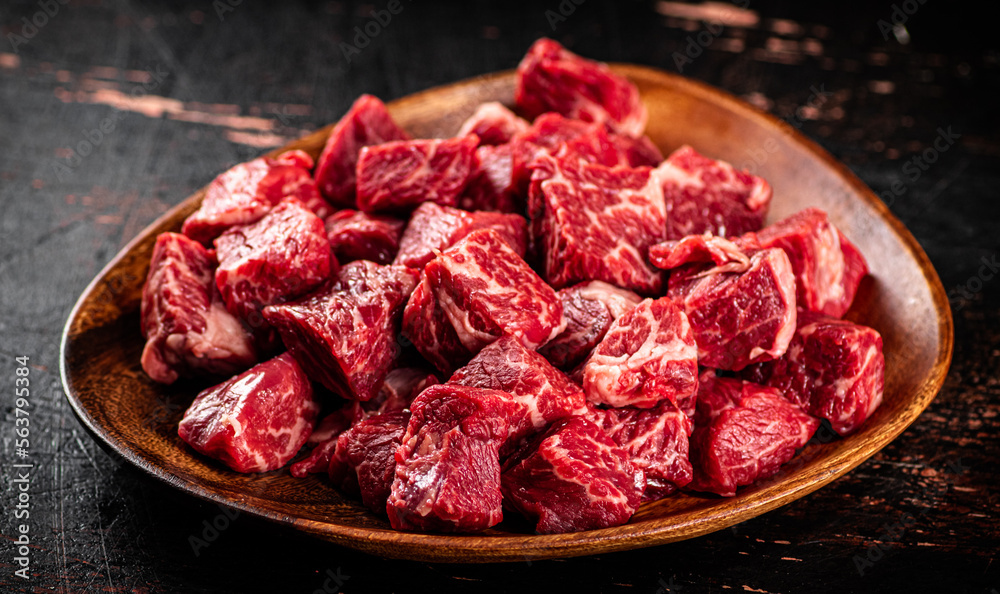 Chunks of fresh raw beef on a plate. Chunks of fresh raw beef on a plate.