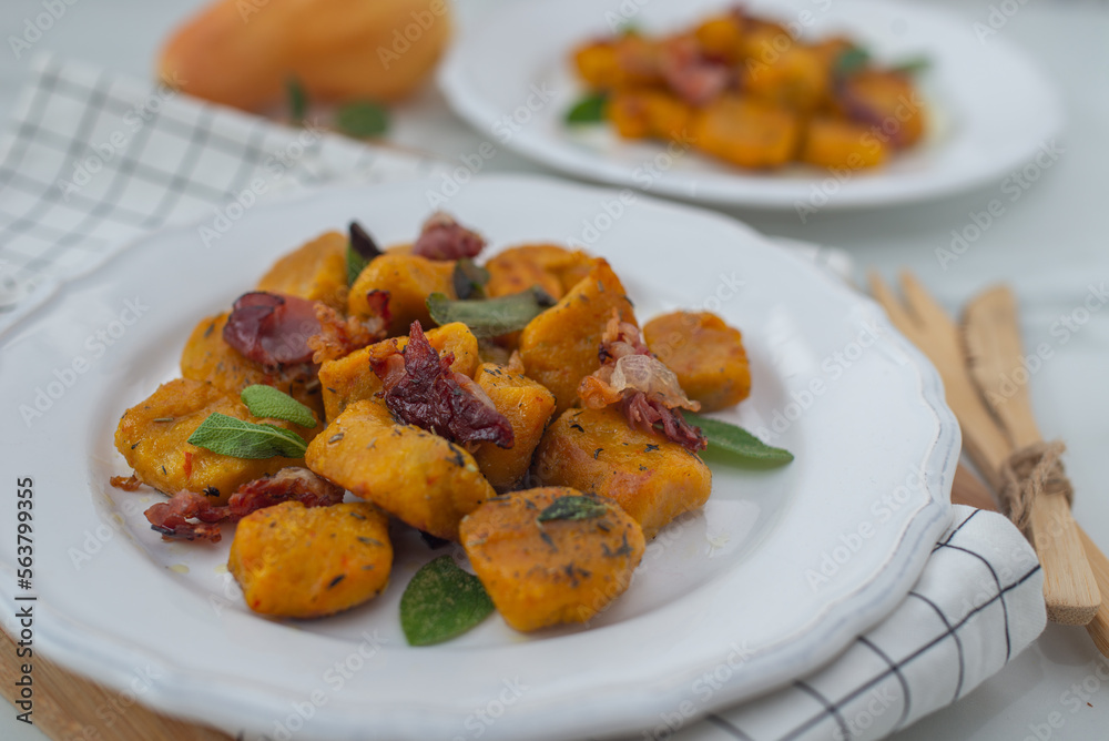 Healthy home made Pumpkin gnocchi with cheese and fresh herbs on a table Healthy home made Pumpkin gnocchi with cheese and fresh herbs on a table