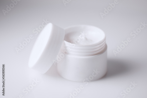 white jar of a cosmetic beauty cream isolated on white background with an open cap