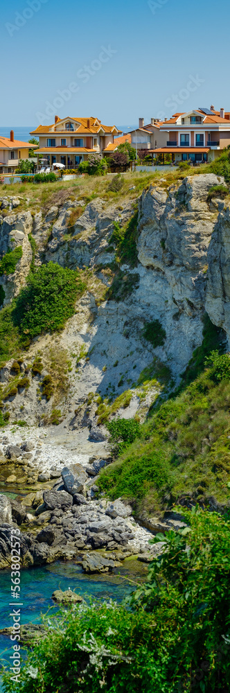 Istanbul, Turkey. The rocky shore of the Black Sea with a cave in Sile, beautiful villas on a hill. Istanbul, Turkey. The rocky shore of the Black Sea with a cave in Sile, beautiful villas on a hill.