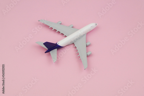 Airplane on pink background with copy space for text. Travel and transportation concept. 