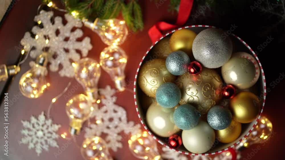 Old box with Christmas toys - golden deer, colorful balls, and tinsel Old box with Christmas toys - golden deer, colorful balls, and tinsel