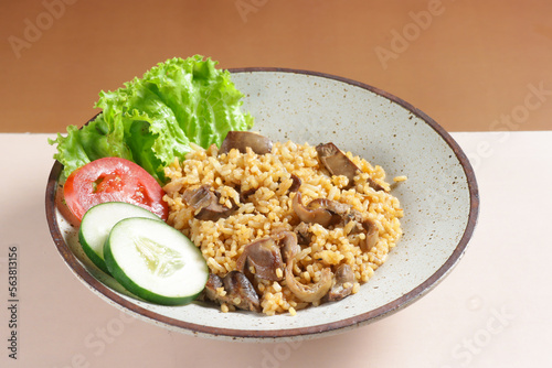 Nasi Goreng hati ampela is Fried Rice with  chicken gizzard heart garnished with fresh cucumber and tomatoes slices. photo
