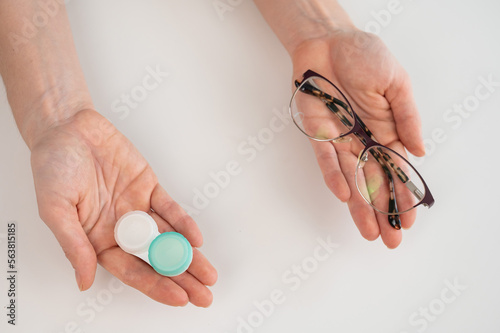 A woman makes a choice between lenses and glasses.
