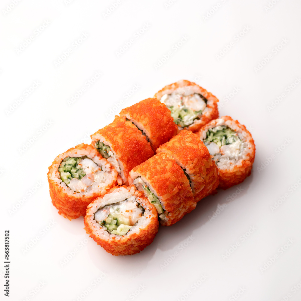 Sushi roll with crab, avocado, cucumber and tobiko caviar. Isolation on a white background. Japanese food. Sushi roll with crab, avocado, cucumber and tobiko caviar. Isolation on a white background. Japanese food.