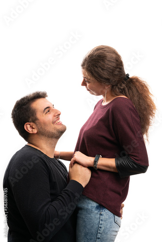 Boyfriend kneeling in front of girlfriend as engagement concept