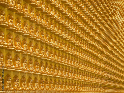 Ten thousand of gold mini buddha statues perfect arrange at Nam Rit Guanyin temple, Uttaradit province, Thailand. photo