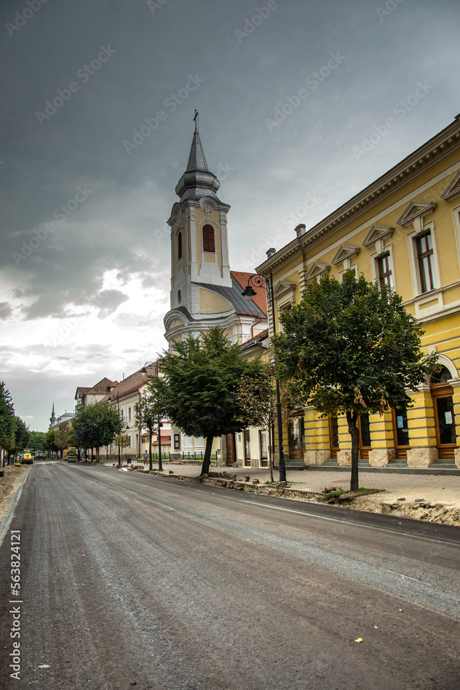Gheorghe Sincai Street newly paved in Bistrita, Romania, August 2022 Roman Catholic Church in the foreground.