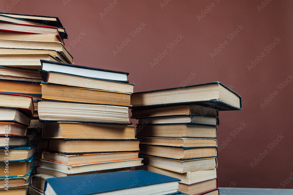 a stack of old instructional books on a brown background a stack of old instructional books on a brown background