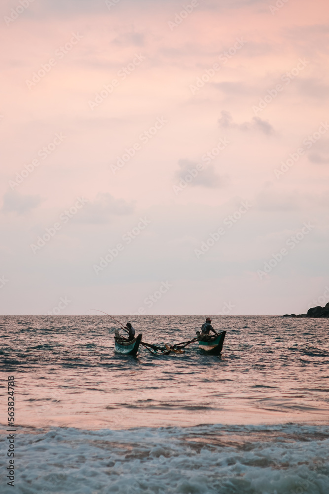 Mirissa, Sri Lanka : Fishermen fishing on their traditional boat on a rough sea
