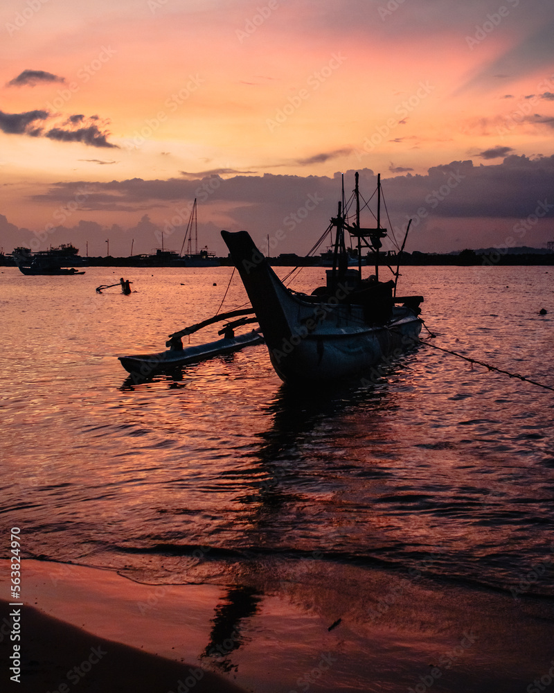 Mirissa, Sri Lanka : a traditional Sri Lankan fishing boat on the port of Mirissa at sunset