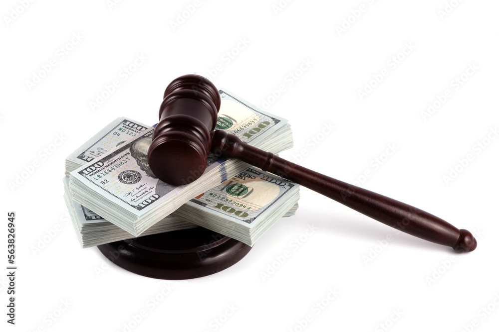 Naklejka premium Judge's gavel and 100 american dollar banknotes on white background