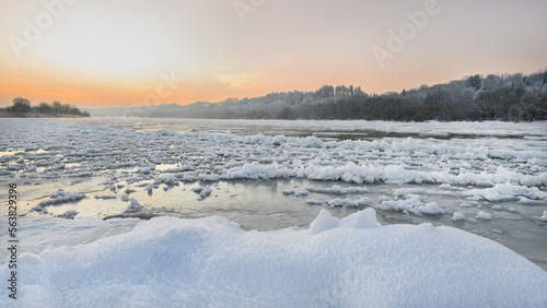 Amazing cold winter morning in Europe. Ice floes floating on a river. Amazing morning sunshine in extreme cold. Nemunas river in Lithuania. Wonderful views, frost, snow, ice stunning landscape.