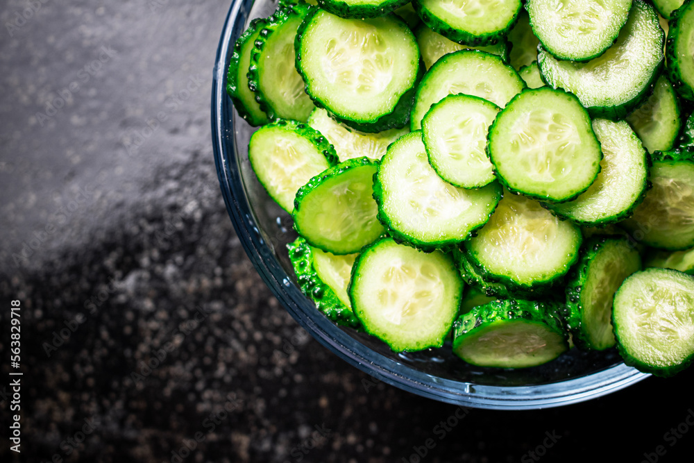 Full glass bowl of chopped fresh cucumbers. Full glass bowl of chopped fresh cucumbers.