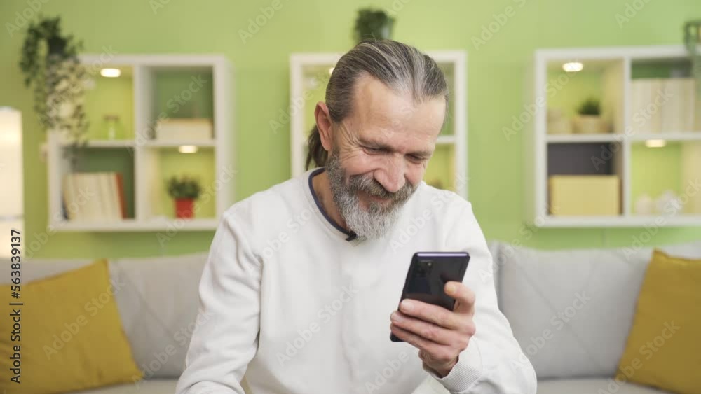 Happy and positive mature man looking at his smartphone at home and smiling.
The middle-aged man looking at the phone is smiling and enjoying what he sees on the screen.
Happy and positive mature man looking at his smartphone at home and smiling.
The middle-aged man looking at the phone is smiling and enjoying what he sees on the screen.