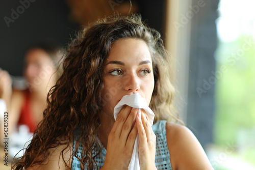 Woman cleaning mouth with a napkin