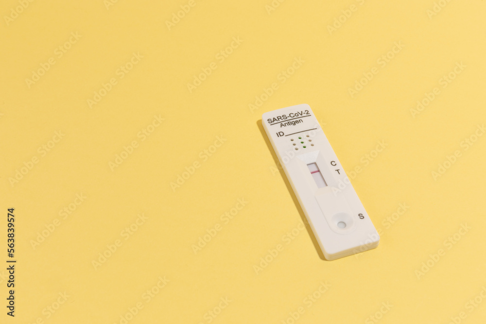 Close up image of Rapid test kit device for Covid-19 on yellow surface Close up image of Rapid test kit device for Covid-19 on yellow surface