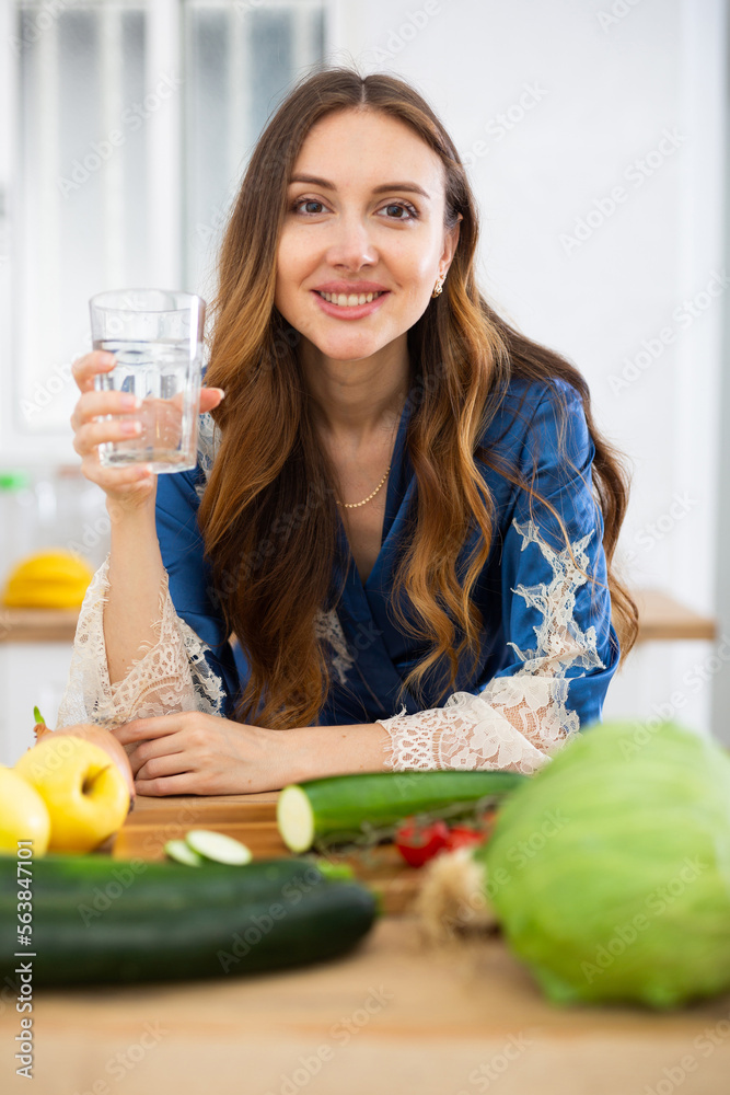 Young attractive woman drinking water at home Young attractive woman drinking water at home