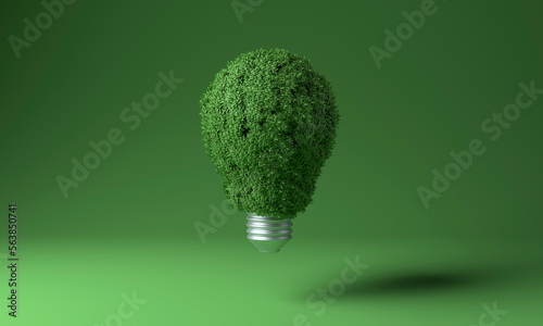 Light bulb covered with green plants against colored background