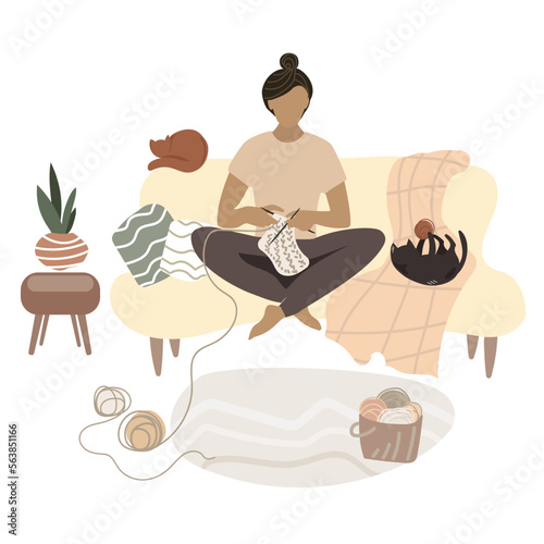 Young woman knits while sitting at home on sofa in a cozy interior,comfortable environment with two cats Vector illustration in flat style.Hobbies and work, manual labor. Warm things connected by hand