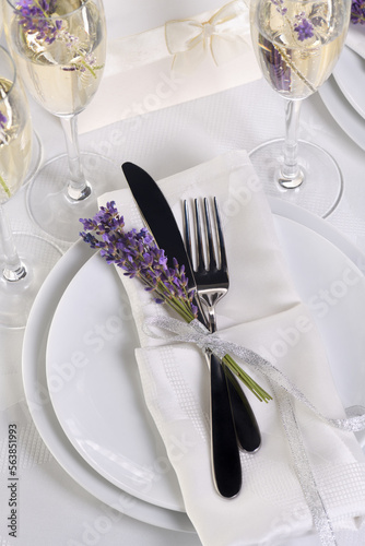 Indulge in a dose of romantic French countryside inspiration with fresh lavender, Lavender Champagne, a folded napkin with cutlery. Detail of the wedding dinner. Wedding theme ideas.