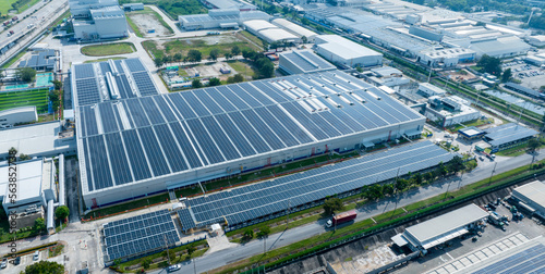 Top view Solar Cell on Warehouse Factory. Solar photo voltaic panels system power or Solar Cell on industrial building roof for producing green ecological electricity. Production of renewable energy.