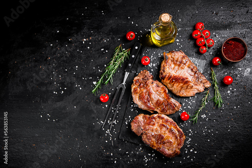 Grilled pork steak with cherry tomatoes and rosemary. 