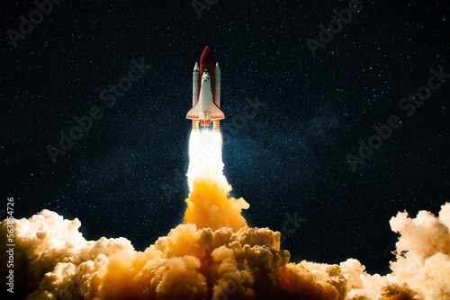 Fototapeta Naklejka Na Ścianę i Meble -  New technological shuttle rocket with blast, fire and smoke successfully takes off into the starry sky. Spaceship launches into dark space with stars. Science and transport, concept