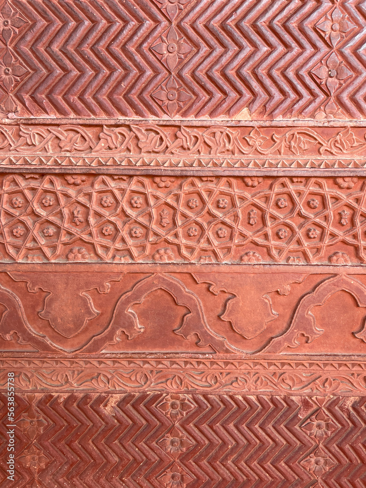 Close up of stone carved ornamental design from Indian heritage site. Details of intricate geometric pattern on the walls of Islamic historical site.