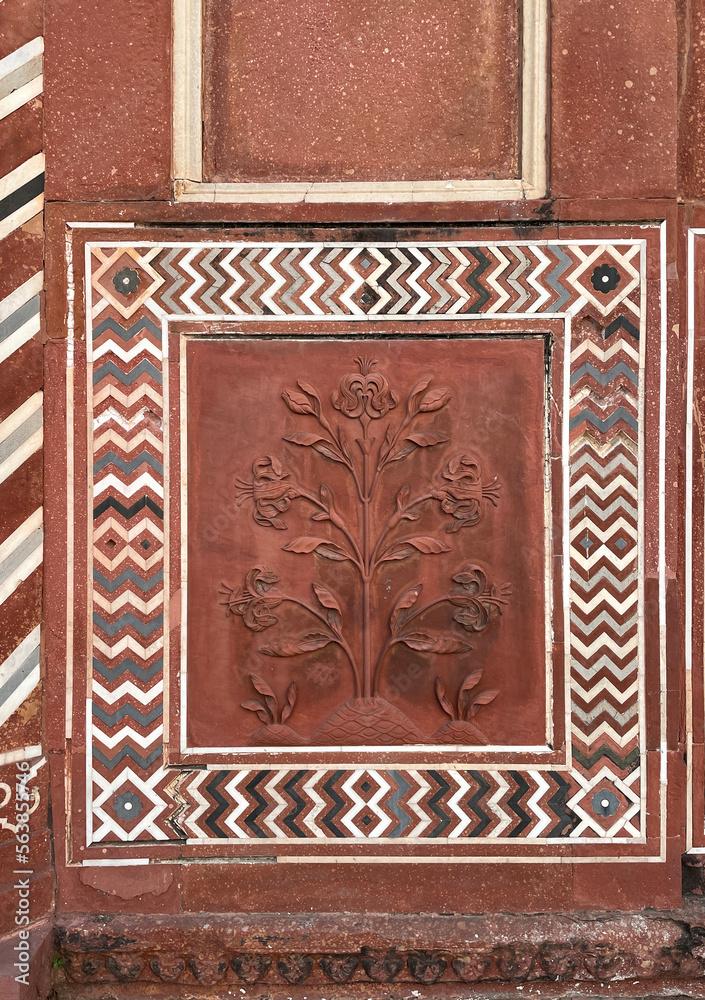 A decorative border and carved floral design on the wall of an ancient building. Details of Mogul art and architecture from Taj Mahal, India. A decorative border and carved floral design on the wall of an ancient building. Details of Mogul art and architecture from Taj Mahal, India.