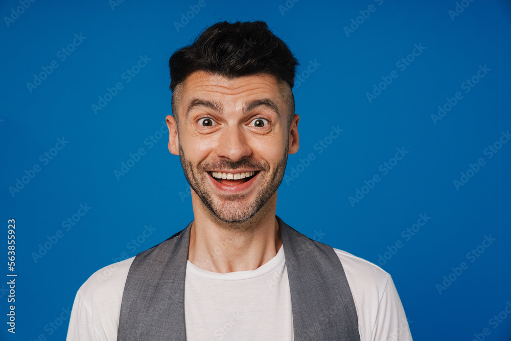 Young white unshaven man smiling and posing at camera Young white unshaven man smiling and posing at camera