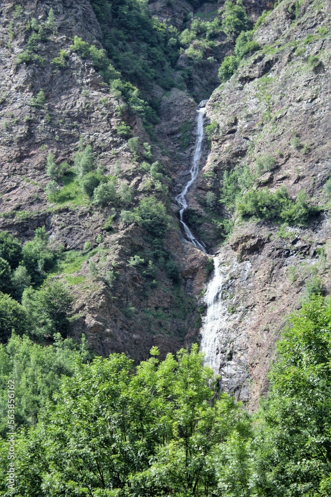 evocative image of a waterfall in the mountains evocative image of a waterfall in the mountains