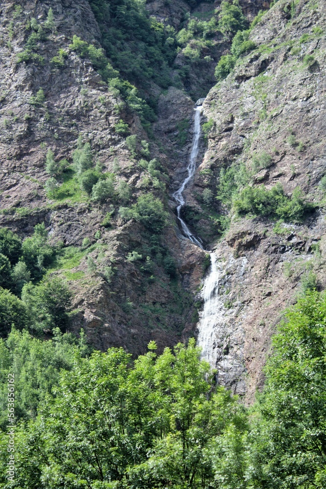 evocative image of a waterfall in the mountains