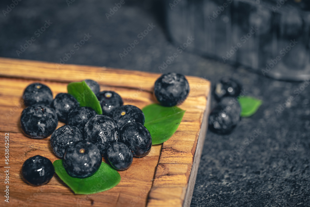 Blueberry berries close-up on a dark blurred background. Blueberry berries close-up on a dark blurred background.