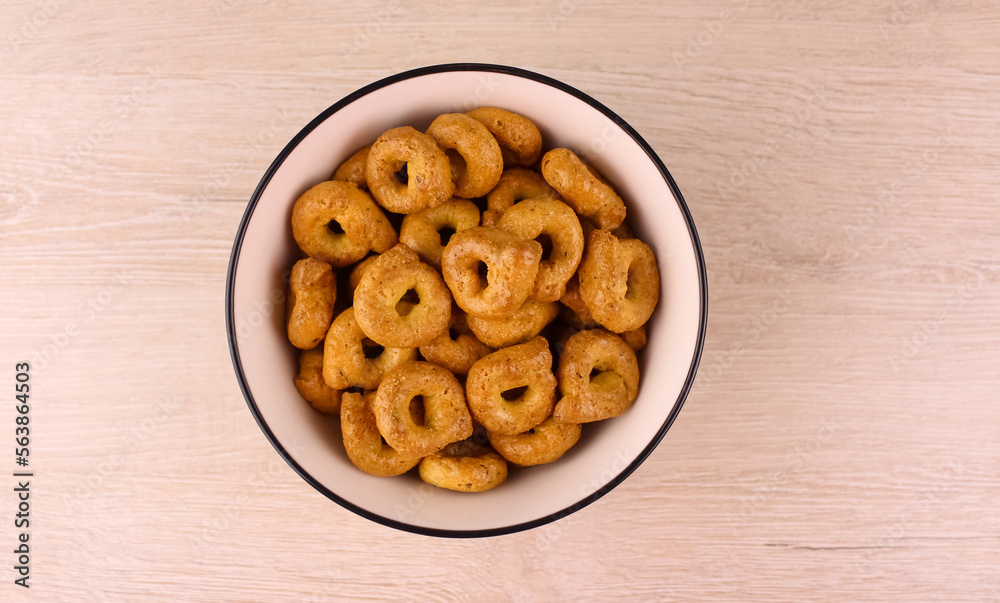 Tarallini in a white plate on a wooden background Tarallini in a white plate on a wooden background