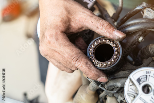 Quadro em tela Mechanic inspect and adjust Motorcycle Steering Head Bearings, maintenance, repair motorcycle concept in garage