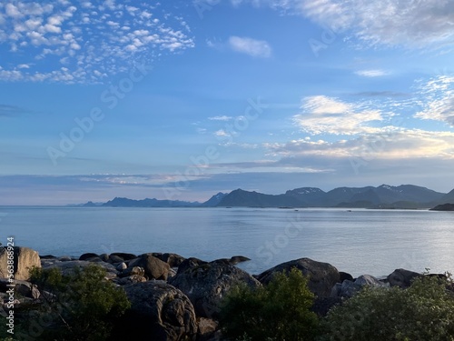 Blue calm ocean bay horizon, small rocky islands, blue sky photo