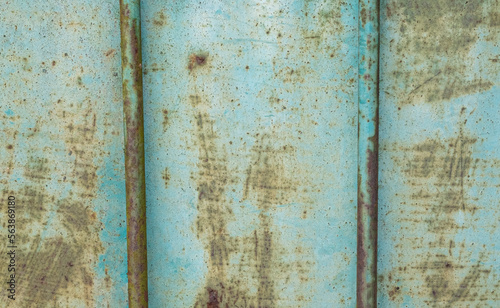 Patina blue and rusted metal panel with two rods grunge background texture