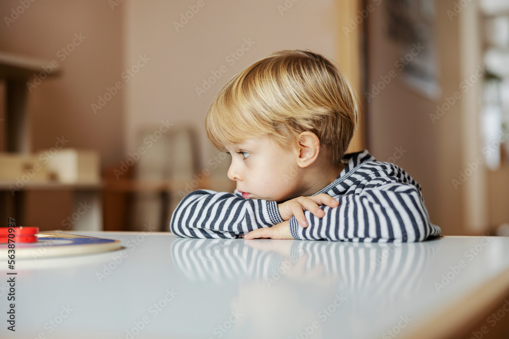 A bored child in kindergarten.
