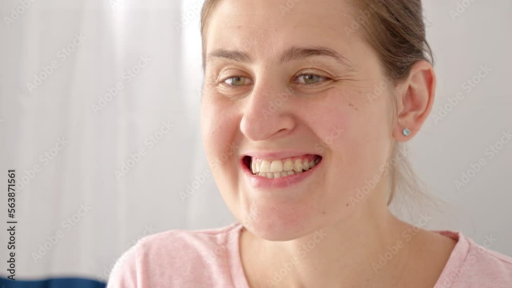 Closeup of woman examining her teeth and checking for plaque. Concept of teeth health, self checking mouth and oral hygiene Closeup of woman examining her teeth and checking for plaque. Concept of teeth health, self checking mouth and oral hygiene