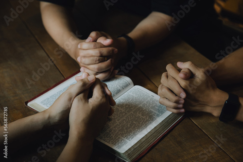Christians and Bible study concept. Christians held each other s hands praying together and seeking the blessings of God   They were reading the Bible and sharing the gospel. praying worship believe.