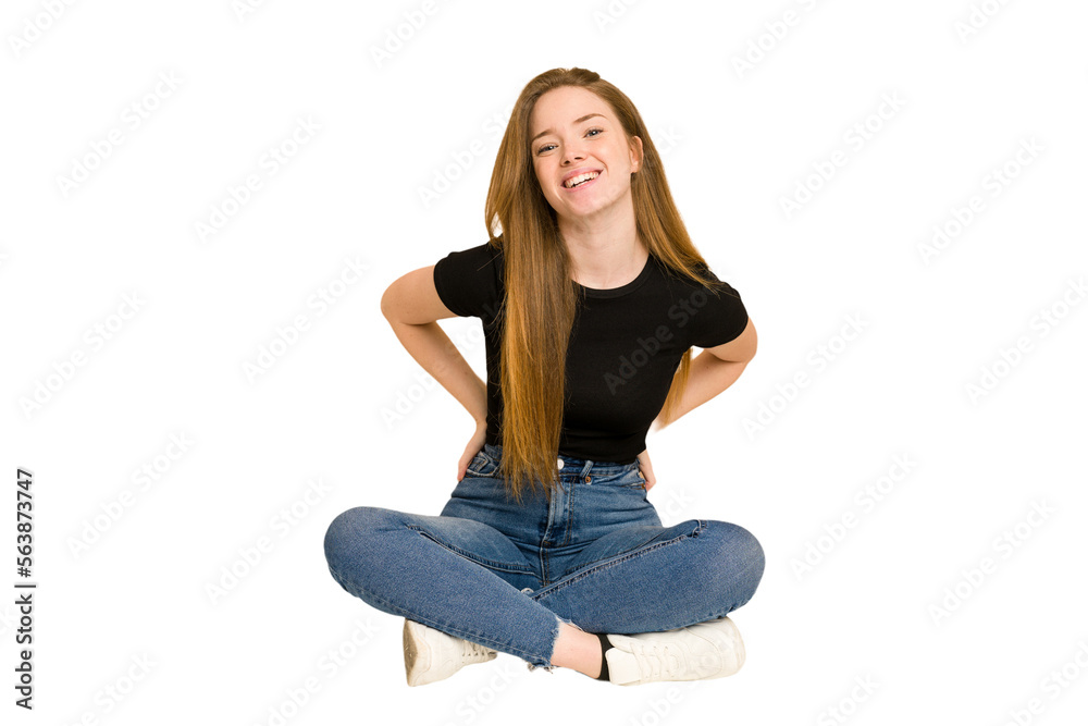 Young redhead woman sitting on the floor cut out isolated happy, smiling and cheerful. Young redhead woman sitting on the floor cut out isolated happy, smiling and cheerful.